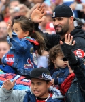 Albert Pujols and his family waives to fans Sunday during the parade.